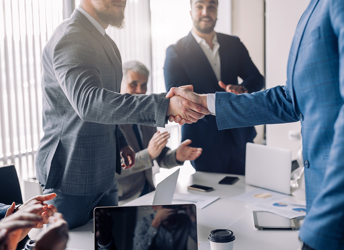 Insurance Solutions - Business People Shaking Hands in an Office